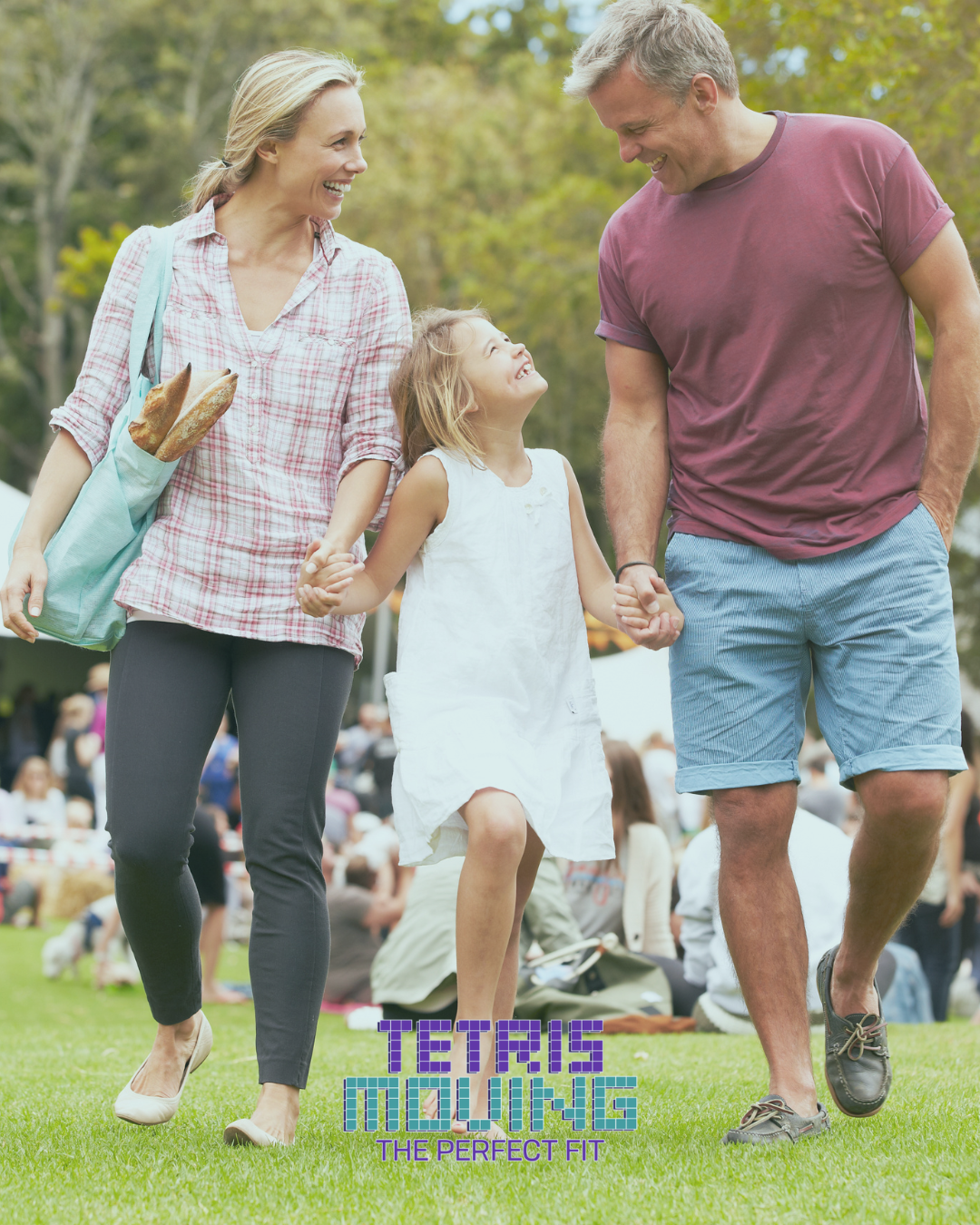 Happy family of 3 walking together in a park