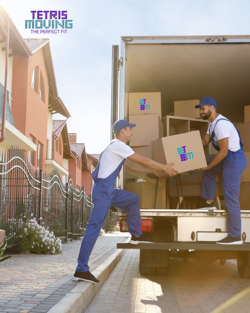 Two tetris moving employees working together to pack a truck