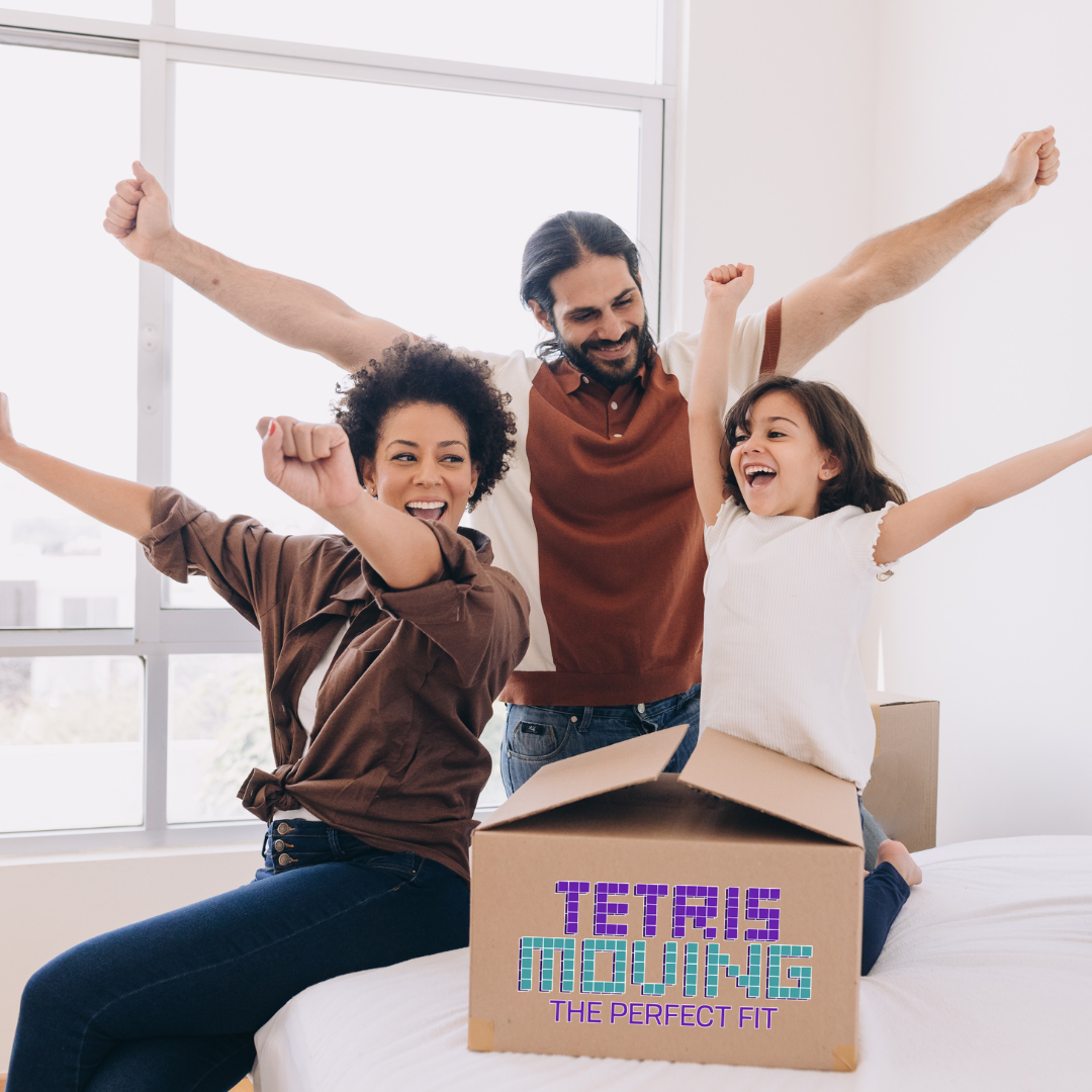 Family of 3 cheering while next to a moving box
