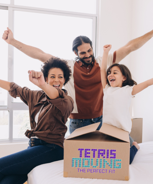 Family of 3 cheering while next to a moving box