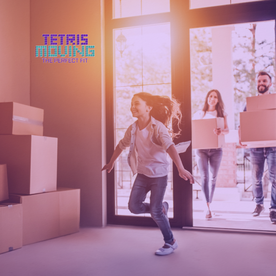 A kid running into a new house with moving boxes littered around the room