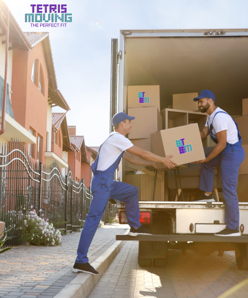 Two tetris moving employees working together to pack a truck