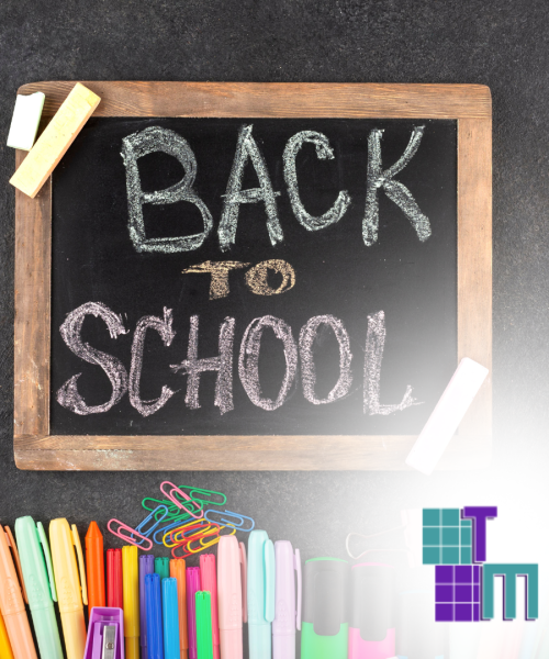 The words "Back to School" written on a blackboard next to colorful markers